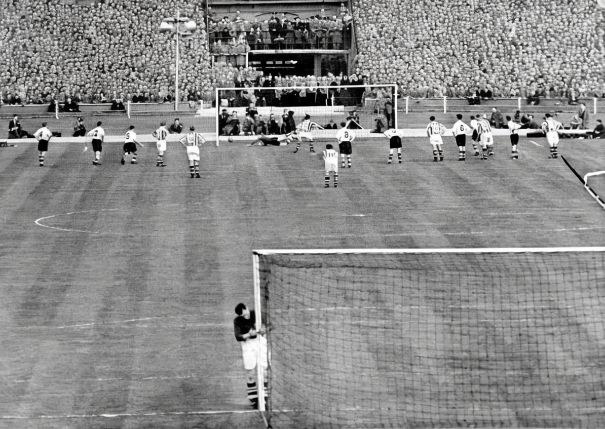 Jimmy Sanders clings to his goalpost as Ronnie Allen scores at the far end during the 1954 FA Cup Final